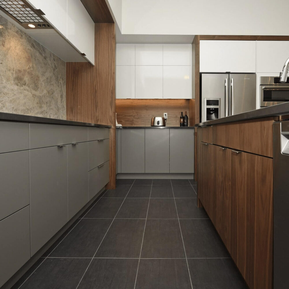 Contemporary kitchen featuring gray cabinets and wooden accents with stainless steel appliances.