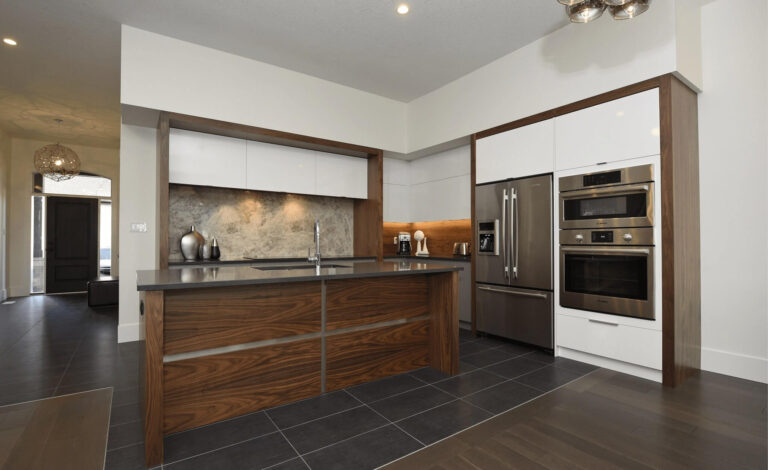 Callingham kitchen by Casey's Kitchens with modern design, walnut wood accents, white high-gloss cabinets, stainless steel appliances, and a marble backsplash.